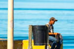 Local Reading The Paper At Laaiplek Harbour, South-Africa